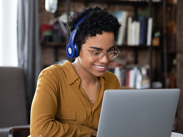 Person wearing headphones using laptop