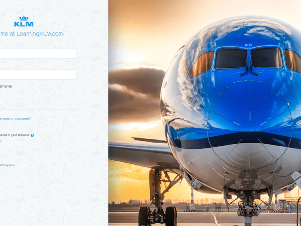 The login screen of KLM's Moodle Workplace platform. It is customised with their logo and branding and it features a photograph of one of their airplanes. Image