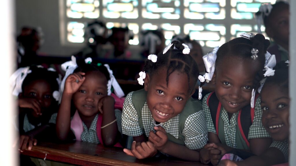 A group of African school children smile in class