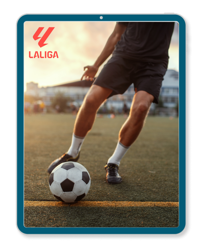Man kicking football on football pitch.